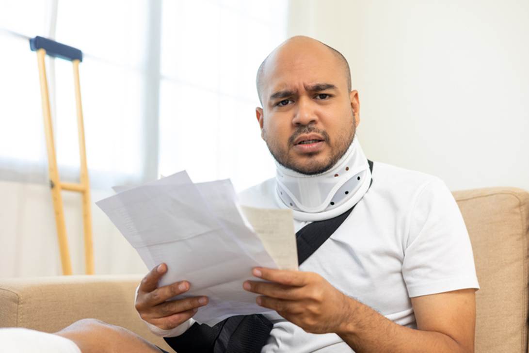 A person with neck brace reading a paper

AI-generated content may be incorrect.